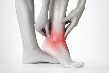 Holding Ankle in Pain